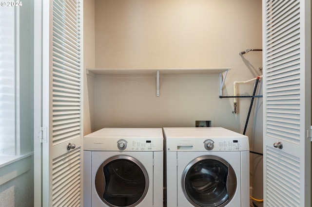 clothes washing area featuring washer and clothes dryer