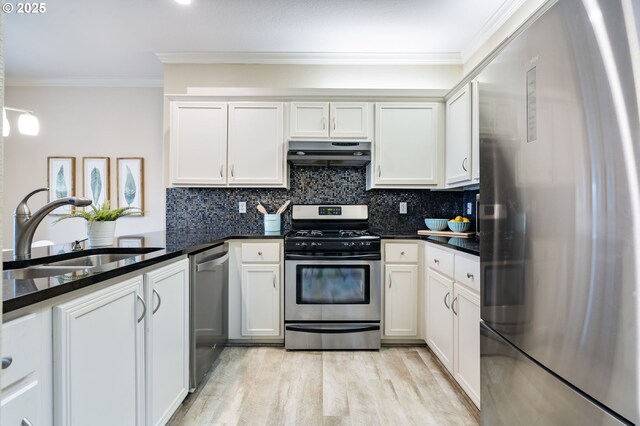 kitchen with sink, stainless steel appliances, extractor fan, and light hardwood / wood-style flooring