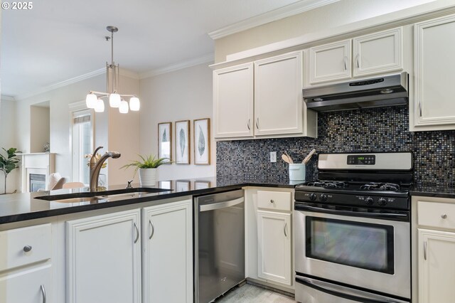 kitchen with sink, light hardwood / wood-style flooring, decorative backsplash, ornamental molding, and appliances with stainless steel finishes