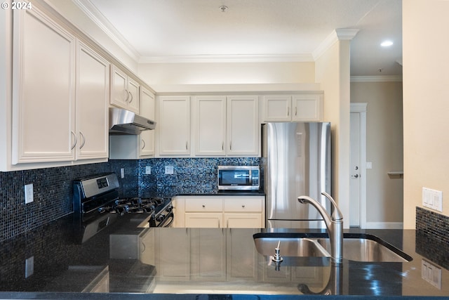 kitchen featuring dark stone counters, crown molding, sink, decorative backsplash, and stainless steel appliances