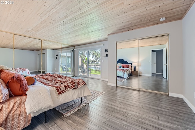 bedroom with hardwood / wood-style flooring, access to exterior, wooden ceiling, and a closet