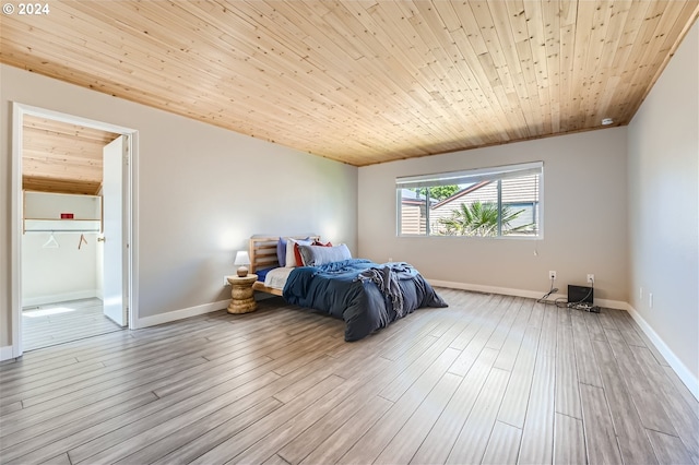 bedroom with wood ceiling and light wood-type flooring