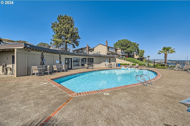 view of swimming pool with a patio