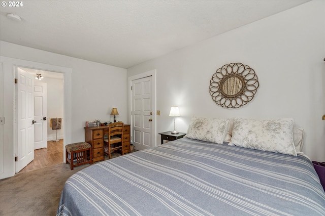 carpeted bedroom featuring a textured ceiling