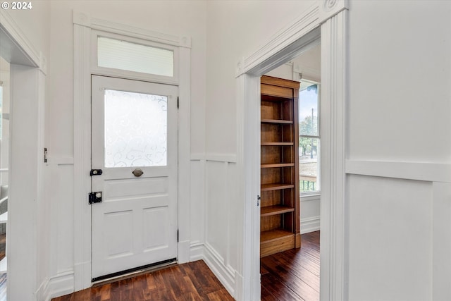 entryway with a wainscoted wall, dark wood-style floors, and a decorative wall