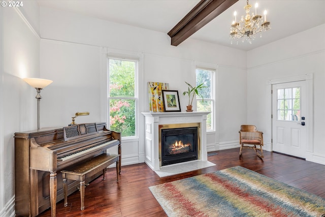 sitting room featuring a fireplace with flush hearth, an inviting chandelier, hardwood / wood-style floors, and beamed ceiling