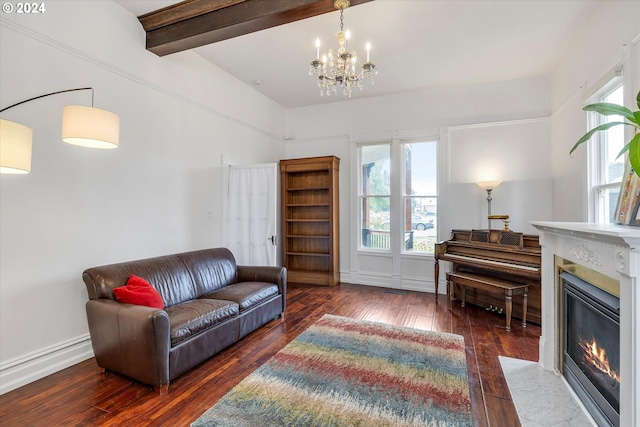 living room featuring an inviting chandelier, beam ceiling, dark wood-type flooring, and a fireplace