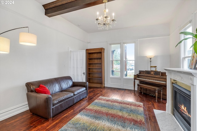 living area with a fireplace with flush hearth, beam ceiling, a notable chandelier, and wood-type flooring
