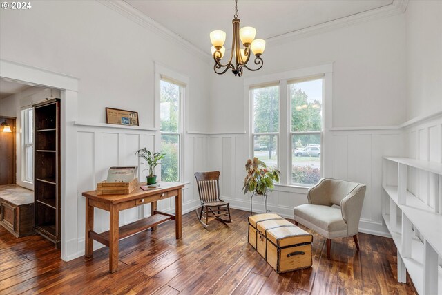 sitting room with crown molding, dark hardwood / wood-style floors, a chandelier, and a wealth of natural light