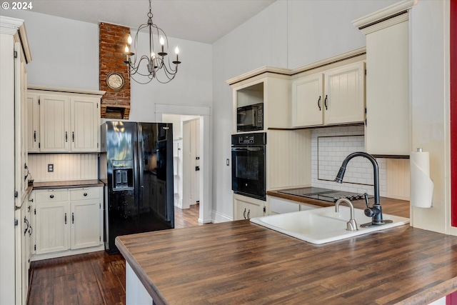 kitchen featuring black appliances, butcher block countertops, backsplash, dark hardwood / wood-style flooring, and hanging light fixtures