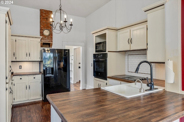 kitchen featuring black appliances, decorative backsplash, a chandelier, a peninsula, and dark wood-style flooring