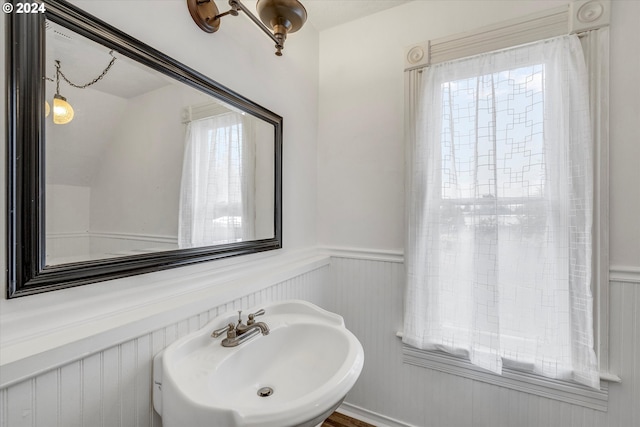 bathroom featuring wainscoting and a sink