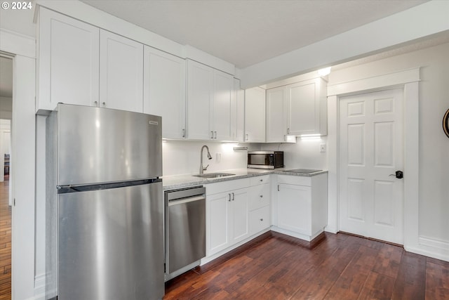 kitchen featuring sink, white cabinetry, stainless steel appliances, and dark hardwood / wood-style flooring