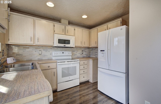 kitchen featuring white appliances, dark wood finished floors, light countertops, light brown cabinetry, and a sink