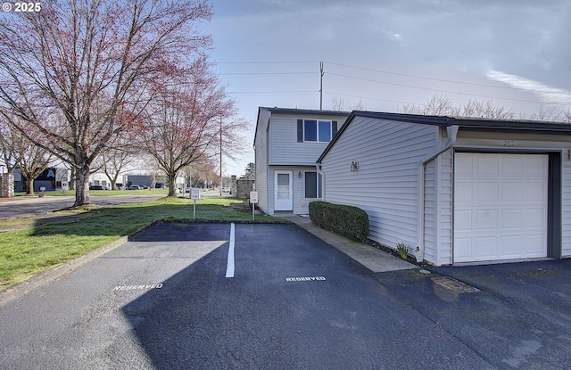 view of home's exterior featuring a garage and a lawn