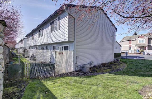 view of side of property with a yard and fence