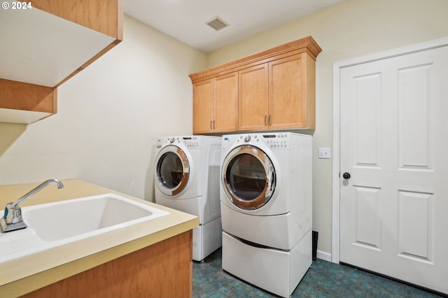 laundry area with cabinets, sink, and washing machine and dryer