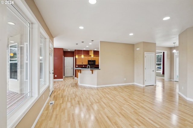 unfurnished living room with light hardwood / wood-style flooring