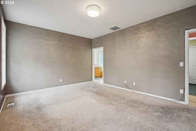 spare room featuring carpet flooring