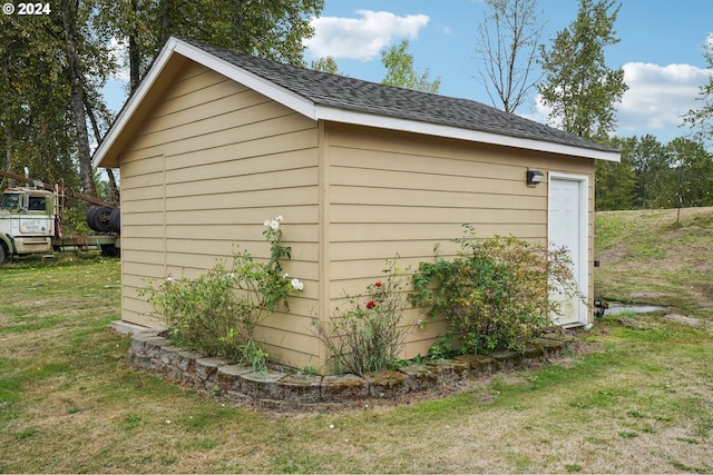 view of outbuilding featuring a yard