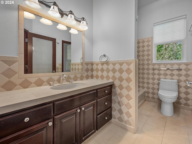 bathroom with tile patterned flooring, vanity, tile walls, and toilet