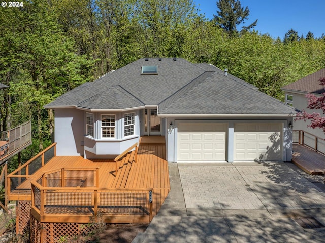 view of front of house featuring a garage and a deck