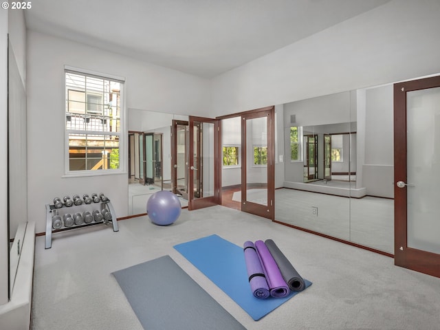 workout room featuring carpet and french doors