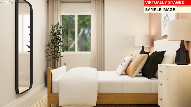 bedroom featuring multiple windows and carpet flooring