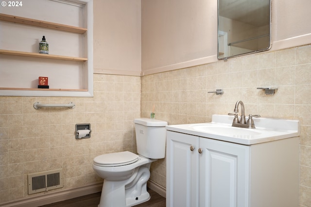 bathroom featuring tile walls, visible vents, toilet, and vanity