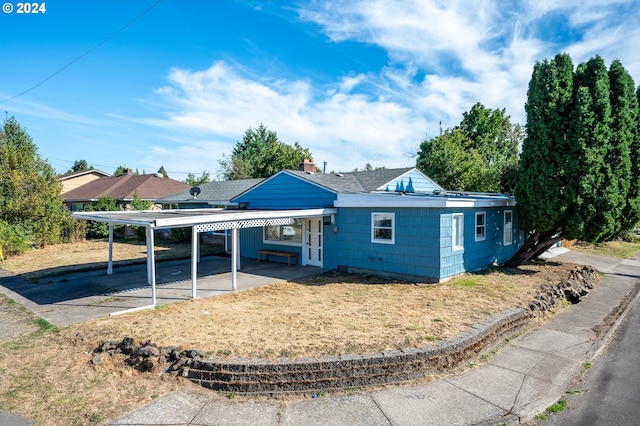 ranch-style house with a carport, french doors, and a patio