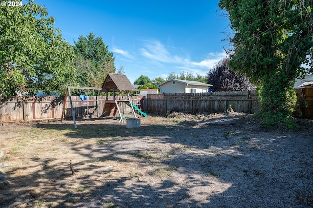 view of yard featuring a fenced backyard and a playground