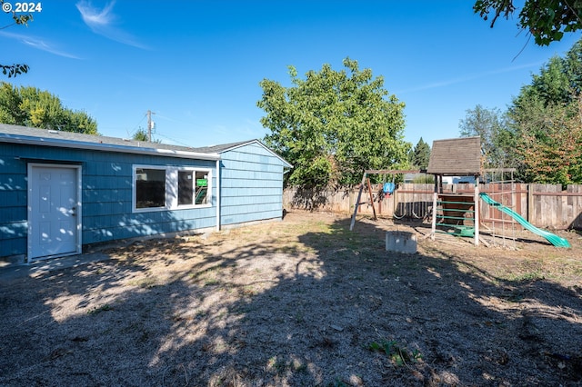 view of yard featuring a playground and fence