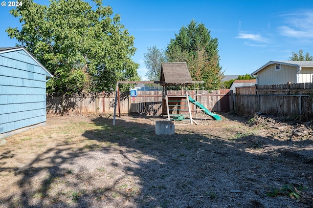 view of yard featuring a fenced backyard and a playground