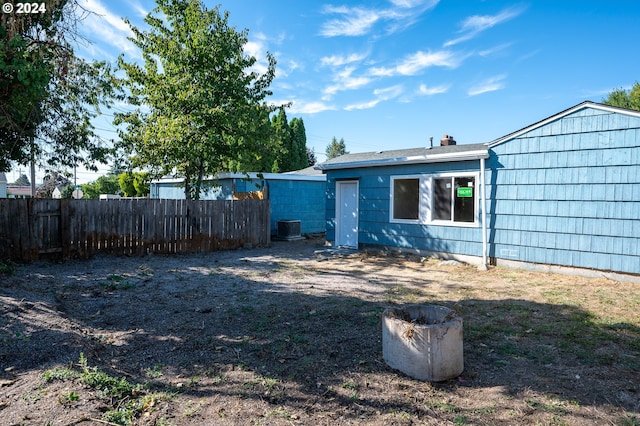 view of yard with central air condition unit and fence