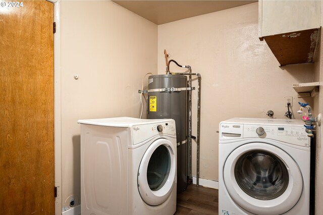 laundry room with separate washer and dryer, dark hardwood / wood-style floors, and water heater