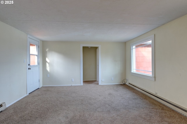 unfurnished room with baseboards, baseboard heating, and light colored carpet