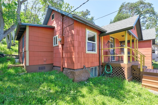 view of property exterior with crawl space and roof with shingles