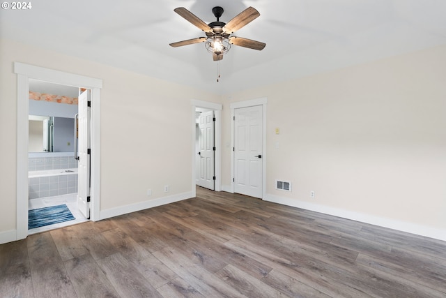 unfurnished bedroom with ensuite bath, ceiling fan, and hardwood / wood-style flooring