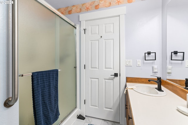 bathroom featuring tile patterned floors, vanity, and a shower with door