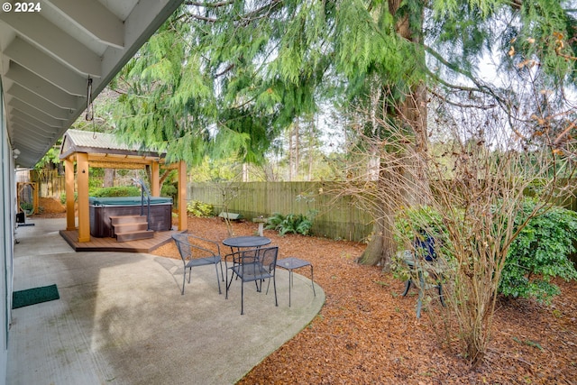 view of patio / terrace with a hot tub