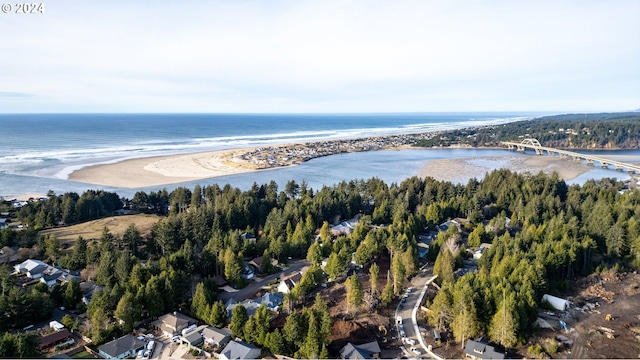 birds eye view of property with a beach view and a water view