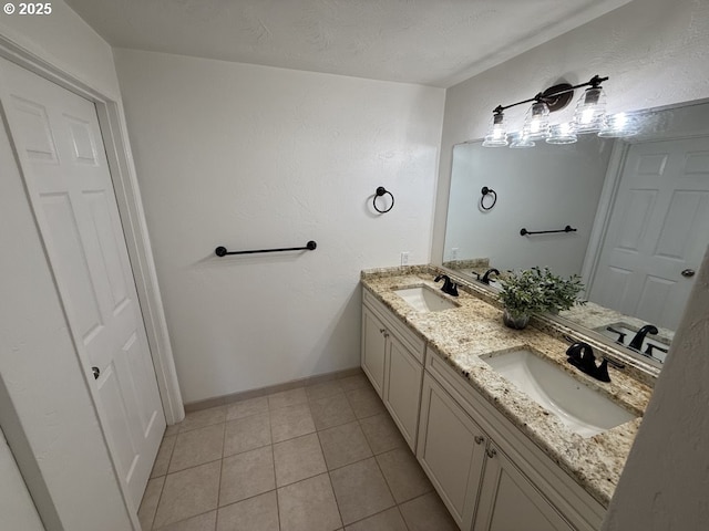 bathroom featuring tile patterned floors, vanity, and a textured ceiling