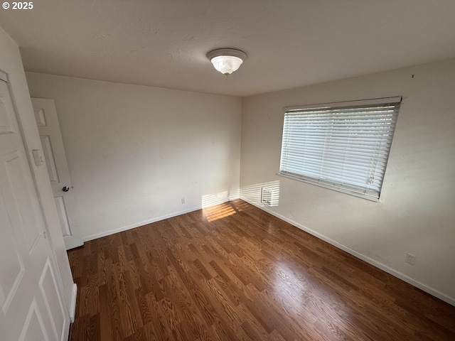 unfurnished room featuring dark hardwood / wood-style floors