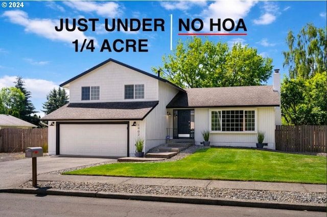 tri-level home with a garage, fence, a front lawn, and concrete driveway