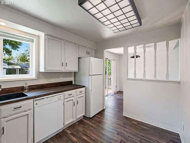 kitchen featuring dark hardwood / wood-style floors, sink, white cabinets, and white appliances