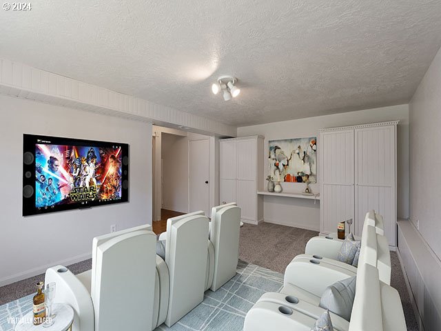 carpeted cinema room with a textured ceiling