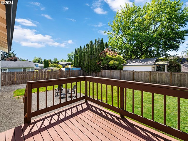 wooden deck featuring a yard