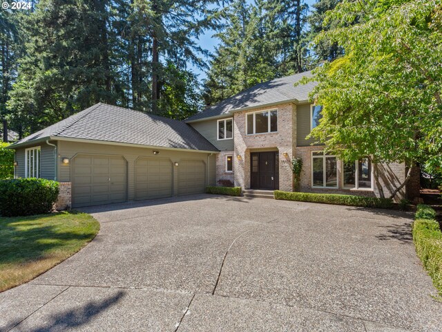 view of front of property with a front yard and a garage