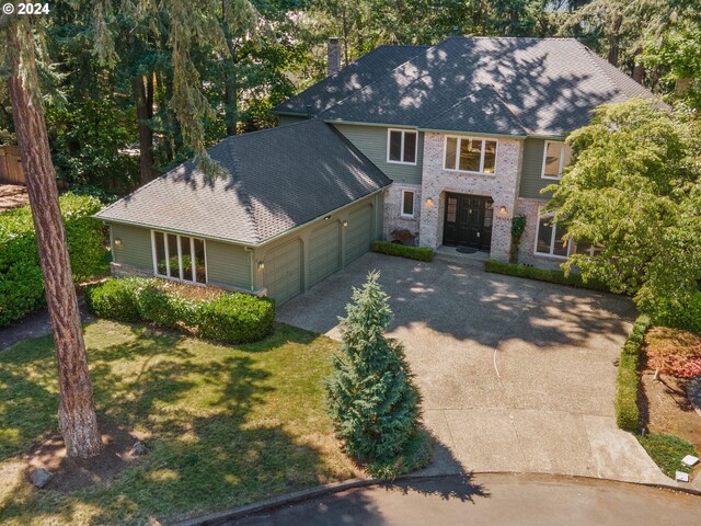 view of front of property featuring a garage and a front lawn