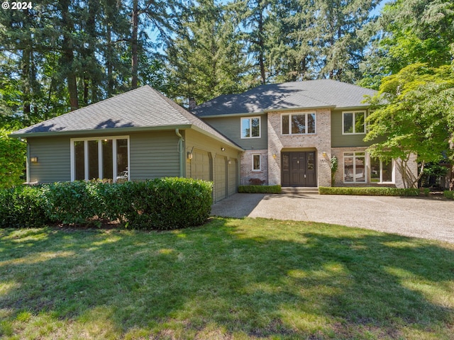 view of front of property featuring a garage and a front lawn